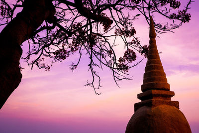 Low angle view of silhouette statue against sky at sunset