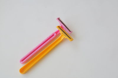 High angle view of colored pencils on white background