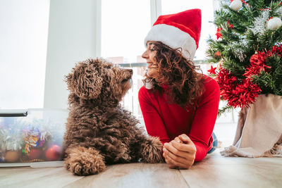 Woman with dog sitting at home. christmas day 