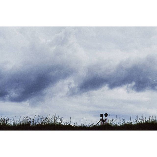 sky, transfer print, lifestyles, leisure activity, cloud - sky, auto post production filter, men, silhouette, full length, cloudy, cloud, bicycle, standing, nature, field, landscape, side view