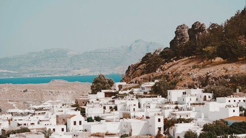 Townscape by sea against clear sky