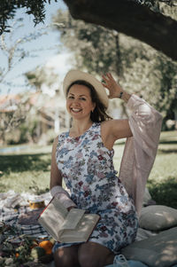 Portrait of young woman sitting on hammock