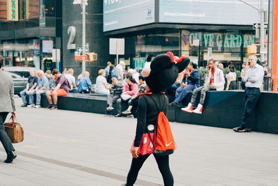 People walking on street in city