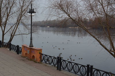 Street by lake against sky