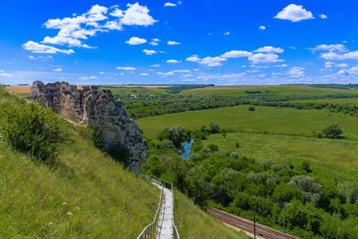 Scenic view of landscape against blue sky