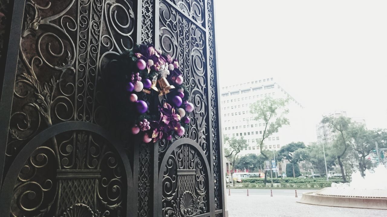 flower, built structure, architecture, building exterior, text, potted plant, clear sky, plant, wall - building feature, day, decoration, outdoors, western script, art, growth, art and craft, no people, wall, creativity, city