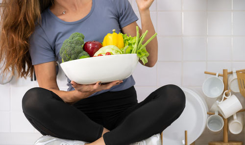 Midsection of woman eating food