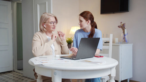 Businesswoman using laptop at home