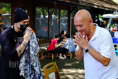 Rear view of people looking at street