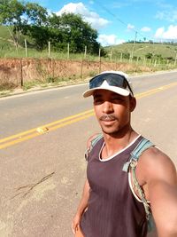 Portrait of man wearing sunglasses on road