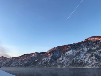 Scenic view of mountains against clear blue sky
