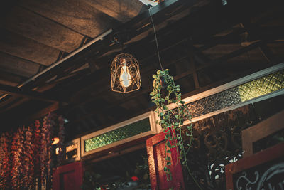 Low angle view of illuminated pendant light hanging from ceiling