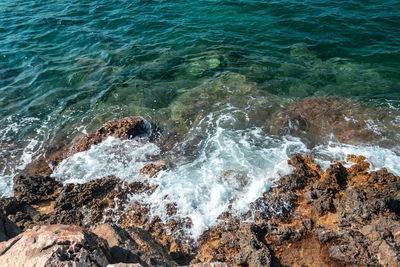 High angle view of rocks in sea