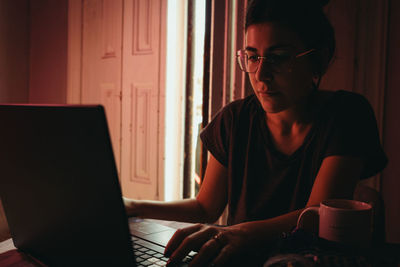 Young man using laptop at table