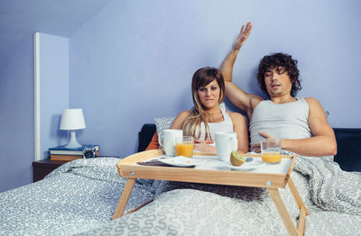 Young couple sitting on table