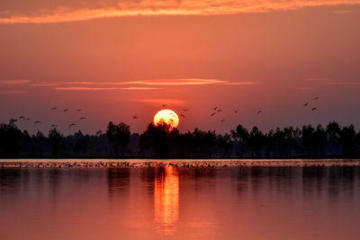 Scenic view of lake against sky during sunset