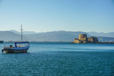 Sailboats in sea against clear blue sky