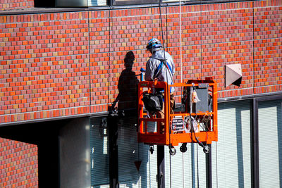 Man working on brick wall