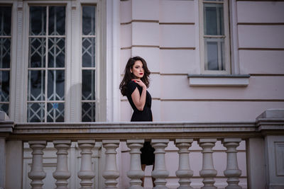 Portrait of woman standing in balcony