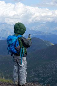 Rear view of man standing on mountain