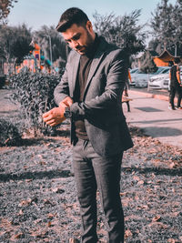 Young man wearing suit standing outdoors