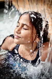 Portrait of smiling young woman in water