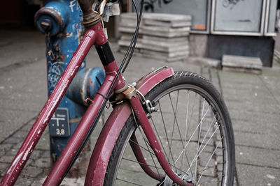 Close-up of bicycle parked on footpath