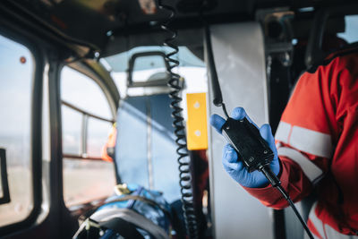 Close-up hand of doctor in surgical gloves inside helicopter of emergency medical service. 