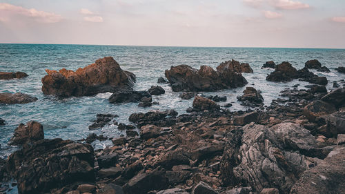 Rocks on beach against sky