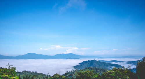Scenic view of mountains against blue sky