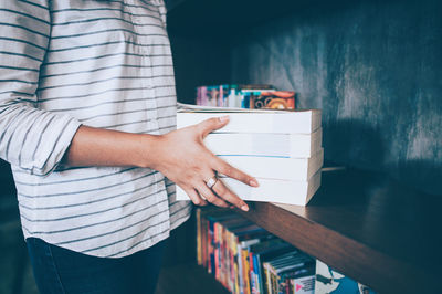 Midsection of man holding book