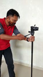 Young man photographing camera