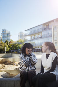 Smiling friends talking together