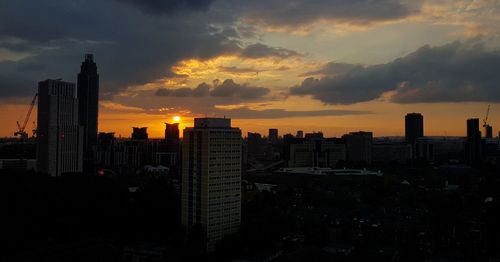Scenic view of buildings against sky during sunset