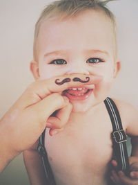 Close-up portrait of a baby with fake moustache