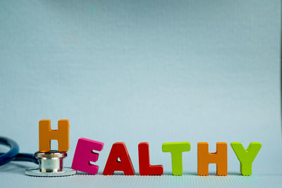 Close-up of text on table against blue background