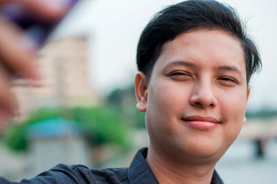 Close-up portrait of young man looking away