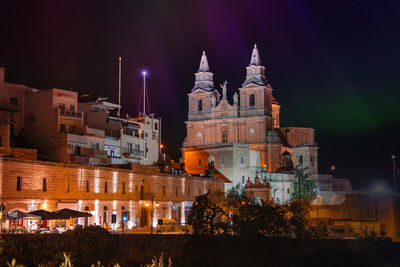 Illuminated buildings in city at night