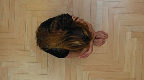 Portrait of woman standing against wall at home