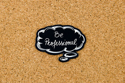 High angle view of text on heart shape on sand