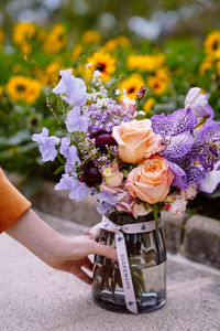 Midsection of woman holding flowers