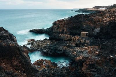 Rocky coastal seascape scenery, small fishing shelter, charco del palo, lanzerote, canaries