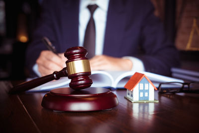 Midsection of man holding coffee cup on table