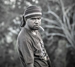 Portrait of man standing against trees