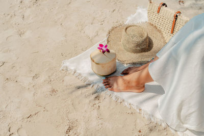 Close-up of wedding dress on sand at sandy beach