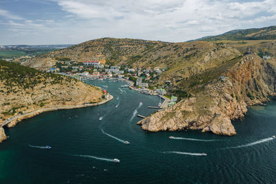 High angle view of bay and mountains against sky