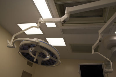 Low angle view of electric lamp hanging on ceiling at home