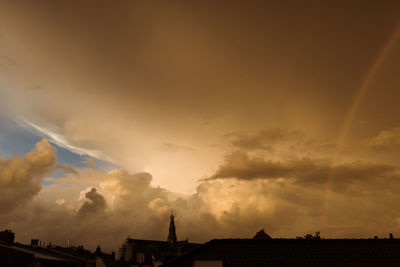 Low angle view of silhouette city against sky