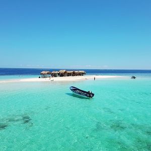 Scenic view of sea against clear blue sky