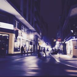 Illuminated city street at night